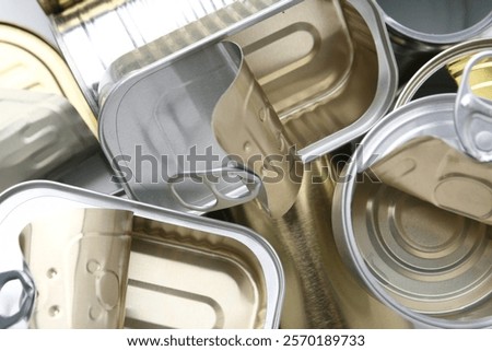 Many open tin cans as background, top view