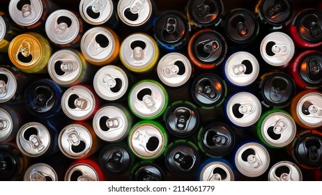 Many opened and drunk cans of different drinks