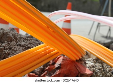 Many Orange Pipes For Fiber Optics In A Large City Road Construction To Connect High Speed Internet