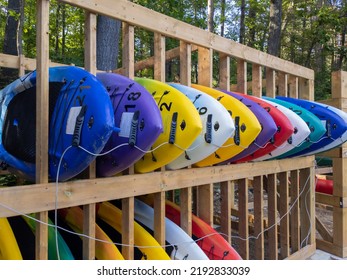 Many Paddle Boards Stacked On A Rack At A Rental Business Facility. Summer Water Sports Concept.