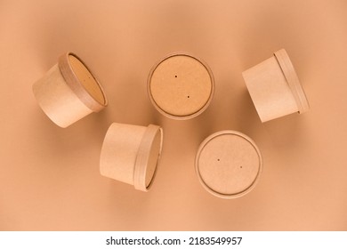Many Paper Food Containers, Cups With Paper Cap Over Light Brown Background With Copy Space, Mockup Image. Sustainable Food Packaging. Monochrome, Flat Lay Style