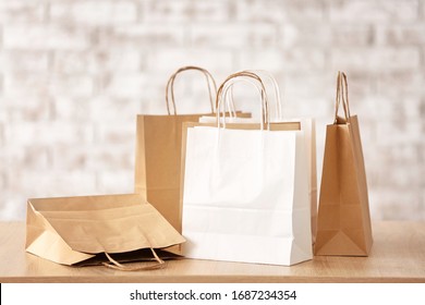 Many Paper Shopping Bags On Table