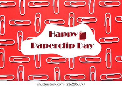 Many paperclips on red background. Greeting card for National Paperclip Day