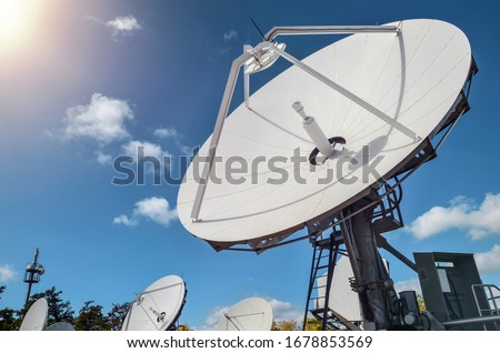 Many parabolic antennas against blue sky