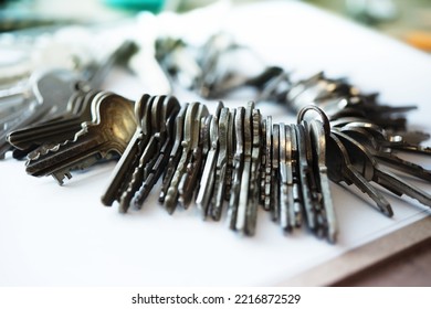 Too many passwords to manage. Password and security concept image. Many metal keys attached to a huge key chain on a desk. - Shutterstock ID 2216872529
