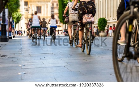 Many people in the city center in the pedestrian zonewho walk on foot and by bicycle