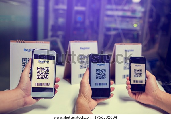 Many of people holdind and using smartphone\
to scan QR code for register. Scan QR code and Barcode for\
registration in to seminar event or meeting. The concept of\
electronic registration.