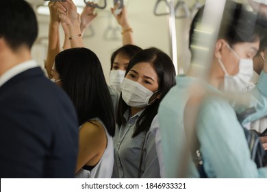 Many People On The Train Wear Anti-virus Masks And Travel During Rush Hours. Business Asian Man On Sky Train.