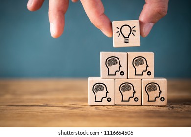 many people together having an idea symbolized by icons on cubes