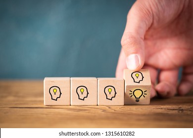 many people together having an idea symbolized by icons on cubes on wooden background
