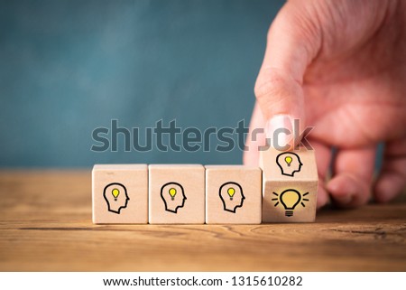 many people together having an idea symbolized by icons on cubes on wooden background