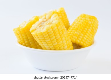 Many pieces of delicious boil corns in white bowl on white background - Shutterstock ID 2055749714