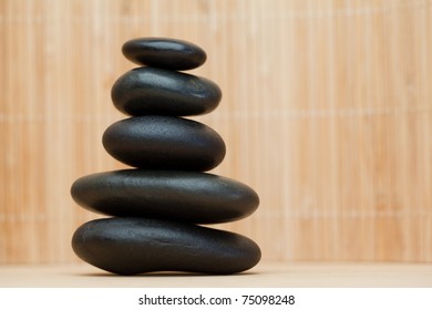 Many piled up pebbles on a brown background