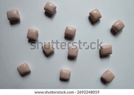 Many pink rectangular pieces of chewing gum from above