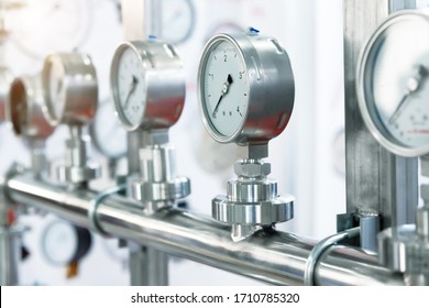 Many pressure gauges mounted on the pipeline. Measuring instruments for pressure control.