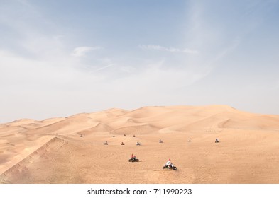 Many Quad Bike ATV Riders Riding At Station On Red Desert Hills Near Dubai In Midday