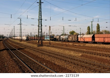 Many railway tracks with some freight trains