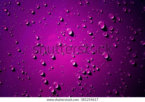 Many\
of raindrops stuck on the Car Hood background,Abstract of raindrops\
on the Car Hood made with dark pink color\
filters.