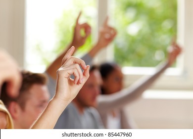 Many raised fingers in class at university - Shutterstock ID 85447960
