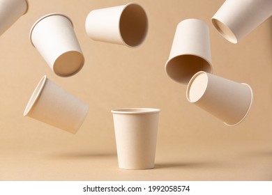 many recyclable cardboard cups floating on a kraft cardboard bottom - Shutterstock ID 1992058574