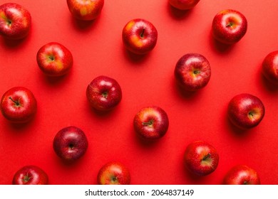 Many red apples on colored background, top view. Autumn pattern with fresh apple above view.