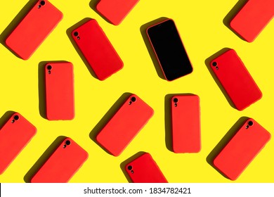 Many Red Cell Phones On Yellow Background. Communication And Gadgets. Bright Pattern