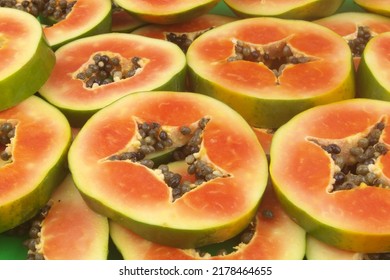 Many Red Papaya Fruit Slices As Background