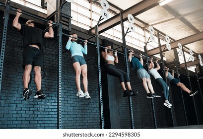 As many reps as we can. Shot of a group of people completing pull ups together. - Powered by Shutterstock