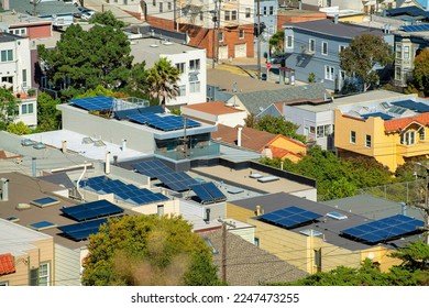 Many rooftops with solar pannels and flat roofs in the historic districts of downtown san francisco california. Clean energy in the city to combat climate change and global warming in neighborhood.