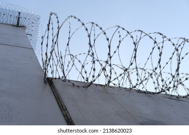 Many Rows Of Barbedwire, High Concrete Fence, Barbed Wire Fence On Top, Building For Execution Of Punishments For Criminals, Concept Prison, Security Zone, Symbol Of Bondage, Hopelessness Of Captivity
