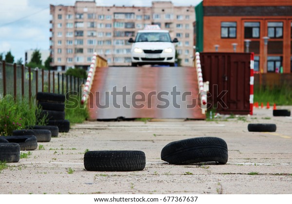 many Rubber tires from wheels are on\
site for training where drivers learn to ride on cars. The driver\
completes the entry and exit from the inclined\
surface