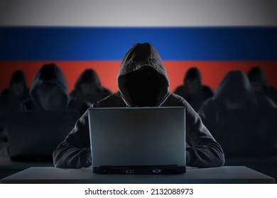 Many russian hackers in troll farm. Cyber crime and security concept. Russia flag in background. - Shutterstock ID 2132088973