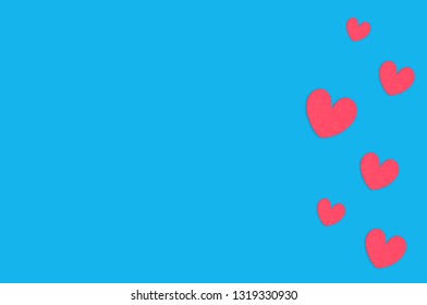 Many scattered red paper hearts on blue table. Top view. Valentines Day concept. Copy space for your text - Shutterstock ID 1319330930
