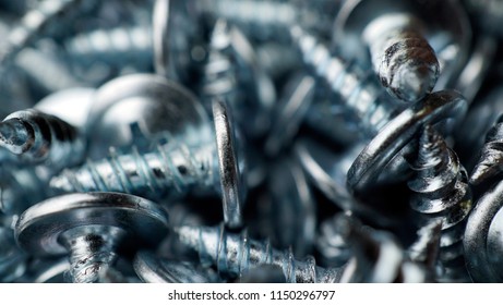 many self tapping screws background. Working tools close up.