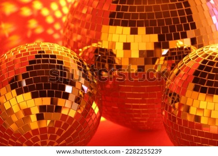 Many shiny disco balls indoors, toned in orange