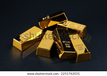 Many shiny gold bars on black background