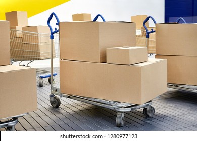 Many shopping carts and boxes on the background of the wall of the mall, shopping and sale concept online. - Powered by Shutterstock