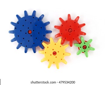 many sizes of colorful plastic gear wheels (blue yellow red green color) connecting isolated on white background, toy that look like engine mechanical part for kid learning, flat lay close up top view - Powered by Shutterstock