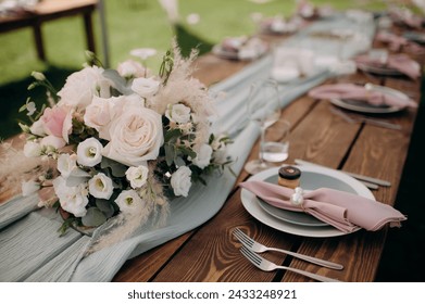 Many small pink and white flower arrangements with roses, eustoma and various flowers in clear glass vases. On the festive table in the wedding banquet area, compositions of flowers and greenery, cand - Powered by Shutterstock