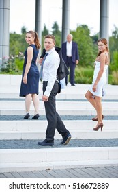 Many Smiling Business People Turning Around On Stairs