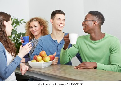 Many Smiling Colleagues Drinking Coffee In Break Room