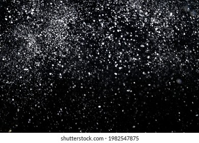 Many snowflakes in blur on black background. Snowfall layer for winter photography.