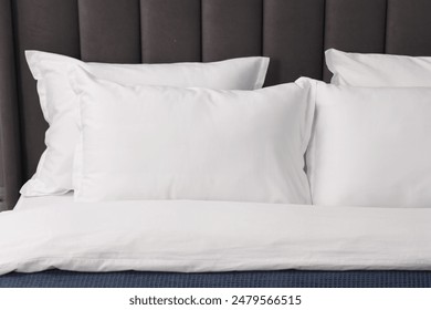 Many soft pillows on bed at home, closeup