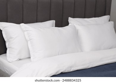 Many soft pillows on bed at home, closeup