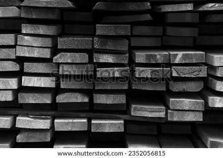 many stacked grey boards. structural light wooden background. the concept of working at a sawmill