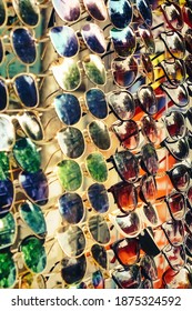 Many Sunglasses Background Texture. Imitation Of Famous Brands.