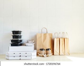 Many Takeaway Paper Bags And Containers On Table In White Bright Room. Takeout Meal, Delivery To Home, Food Delivery, Online Shopping Concept