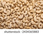 Many tasty cashew nuts as background, top view