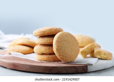 Many tasty sugar cookies on wooden board