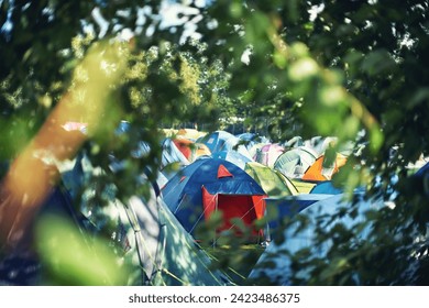 Many tents, camping and outdoor in nature for a music festival. Row of rainbow marquees placed on ground at musical soiree, entertainment event and carnival celebration, relax on holiday campsite - Powered by Shutterstock